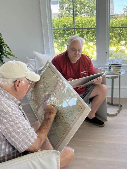 Recipients of rare maps purchased from Anne Hall Antique Prints Gallery in Newport Rhode Island. Two men examining their Newport maps from the 1800's.